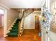 Inviting foyer featuring hardwood floors, a staircase, and a decorative front door at 3290 Spain Rd, Snellville, GA 30039