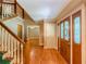 Elegant foyer with hardwood floors, staircase, and paneled doors with glass inserts at 3290 Spain Rd, Snellville, GA 30039