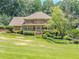 Beautiful two-story brick home with a well-manicured lawn and mature landscaping at 3290 Spain Rd, Snellville, GA 30039