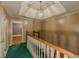 Second floor hallway with wood railing and decorative light fixture above at 3290 Spain Rd, Snellville, GA 30039