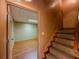 Hallway with stairs and door that leads to a bedroom with wood flooring and a large window at 3290 Spain Rd, Snellville, GA 30039