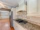 Kitchen features granite countertops, gas stovetop and stainless steel refrigerator at 3290 Spain Rd, Snellville, GA 30039