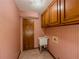 Laundry room features built in cabinets and utility sink at 3290 Spain Rd, Snellville, GA 30039