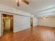 Spacious living room with hardwood floors and ceiling fan and access to other rooms at 3290 Spain Rd, Snellville, GA 30039