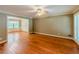 Bright living room featuring hardwood floors, crown molding, and access to the dining room at 3290 Spain Rd, Snellville, GA 30039