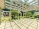 Spacious outdoor patio with a pergola, fireplace, and lush landscaping offers an ideal space for relaxation and entertaining at 3290 Spain Rd, Snellville, GA 30039