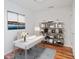 Bright home office with a modern white desk, stylish shelving unit, and a decorative rug at 3325 Piedmont Ne Rd # 2104, Atlanta, GA 30305