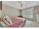 Cozy bedroom featuring a twin bed, neutral walls, a ceiling fan, and a double window at 6302 Manassas Nw Pass, Acworth, GA 30101