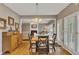 Bright dining room featuring hardwood floors, modern lighting, and a view of the living room at 6302 Manassas Nw Pass, Acworth, GA 30101
