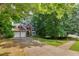 Two-story brick home with a two-car garage, lush landscaping, and a long driveway at 6302 Manassas Nw Pass, Acworth, GA 30101