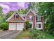 Charming two-story brick home with a two-car garage and manicured front lawn with beautiful roses at 6302 Manassas Nw Pass, Acworth, GA 30101