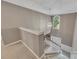 View from the staircase of a 2-story foyer featuring a large window, modern light fixture, and neutral paint colors at 6302 Manassas Nw Pass, Acworth, GA 30101