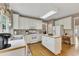 Bright kitchen featuring white cabinetry, stainless appliances, a center island, and hardwood floors at 6302 Manassas Nw Pass, Acworth, GA 30101