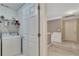 Upstairs laundry room near an entry featuring neutral paint and flooring and full-size washer and dryer at 6302 Manassas Nw Pass, Acworth, GA 30101