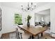 Dining area with wood table, stylish chandelier, and neutral decor at 1606 Van Epps Se St, Atlanta, GA 30316