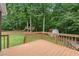 View of backyard deck overlooking spacious yard with a shed and custom playhouse at 2060 Candlewood Ne Ct, Marietta, GA 30066