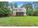 Rear view of home featuring a large yard, deck, and screened-in porch at 2060 Candlewood Ne Ct, Marietta, GA 30066