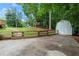 Paved area leads to a backyard featuring a storage shed and playhouse at 2060 Candlewood Ne Ct, Marietta, GA 30066