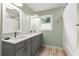 Bright bathroom featuring a double vanity with granite counters and modern fixtures at 2060 Candlewood Ne Ct, Marietta, GA 30066