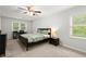 Serene bedroom with neutral carpet, a ceiling fan, and natural light from two windows at 2060 Candlewood Ne Ct, Marietta, GA 30066
