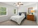 Charming bedroom with a dresser, a mirror and comfy bed, enhanced by natural light, for a serene ambiance at 2060 Candlewood Ne Ct, Marietta, GA 30066