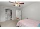 Inviting bedroom with a ceiling fan, closet, and cozy bed, creating a comfortable and private retreat at 2060 Candlewood Ne Ct, Marietta, GA 30066