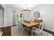 Bright dining room with a rustic table, contemporary chandelier, and large windows at 2060 Candlewood Ne Ct, Marietta, GA 30066