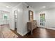 Inviting entryway with hardwood floors, white trim, and a view of the modern kitchen beyond at 2060 Candlewood Ne Ct, Marietta, GA 30066