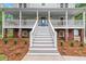 Welcoming front porch with stairs leading to the entrance, accented by lush landscaping and charming details at 2060 Candlewood Ne Ct, Marietta, GA 30066