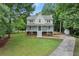 Inviting two-story home with a spacious front yard and a long driveway leading to a detached garage at 2060 Candlewood Ne Ct, Marietta, GA 30066