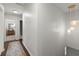 Well-lit hallway with unique pendant lighting, neutral walls, and stylish runner, leading to bedrooms at 2060 Candlewood Ne Ct, Marietta, GA 30066