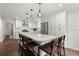 Spacious kitchen features an island with bar seating, stainless appliances, and stylish pendants at 2060 Candlewood Ne Ct, Marietta, GA 30066