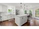 Gourmet kitchen with a large center island, stainless appliances, and modern pendant lights at 2060 Candlewood Ne Ct, Marietta, GA 30066