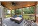 Cozy screened porch with wood ceiling, ceiling fan, and comfortable wicker furniture at 2060 Candlewood Ne Ct, Marietta, GA 30066