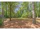 Large wooded backyard with a playset, stairs, and mature trees at 5396 Turnbill Nw Pt, Acworth, GA 30101