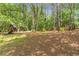 Spacious backyard featuring mature trees and a playset at 5396 Turnbill Nw Pt, Acworth, GA 30101