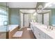 The bathroom features tile floors, double sinks, and soaking tub with glass door and windows at 5396 Turnbill Nw Pt, Acworth, GA 30101