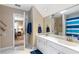 Bright bathroom featuring double sinks, large mirrors, and neutral decor with decorative oars at 5396 Turnbill Nw Pt, Acworth, GA 30101
