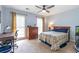 This cozy bedroom features a ceiling fan and plenty of natural light from two large windows at 5396 Turnbill Nw Pt, Acworth, GA 30101