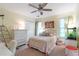 Bright bedroom with ceiling fan, double closet, windows, and a comfortable bed at 5396 Turnbill Nw Pt, Acworth, GA 30101