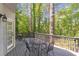 Back deck with table and chairs overlooking a wooded lot at 5396 Turnbill Nw Pt, Acworth, GA 30101