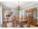 Dining room features a chandelier, hutch, rug, and access to other areas at 5396 Turnbill Nw Pt, Acworth, GA 30101