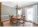 Dining room featuring a chandelier, area rug, and plentiful natural light at 5396 Turnbill Nw Pt, Acworth, GA 30101