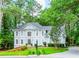 Traditional two-story home with a well-maintained lawn, mature trees, and a charming mailbox at 5396 Turnbill Nw Pt, Acworth, GA 30101