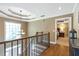Hallway showcasing the elegant staircase and chandelier at 5396 Turnbill Nw Pt, Acworth, GA 30101