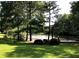 Scenic view of a serene lake with a wooden pier surrounded by lush greenery at 5396 Turnbill Nw Pt, Acworth, GA 30101