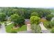 Aerial shot of a brick house showcasing a well-manicured lawn and charming neighborhood setting at 10865 Misty Moon Ct, Alpharetta, GA 30022