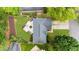Aerial view of the house showing the backyard's stone patio surrounded by green grass at 10865 Misty Moon Ct, Alpharetta, GA 30022