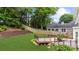 View of a lush backyard featuring a wooden deck with black railings and a well-maintained lawn at 10865 Misty Moon Ct, Alpharetta, GA 30022