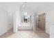 Bright bathroom features a soaking tub under a large window and a glass block shower enclosure at 10865 Misty Moon Ct, Alpharetta, GA 30022